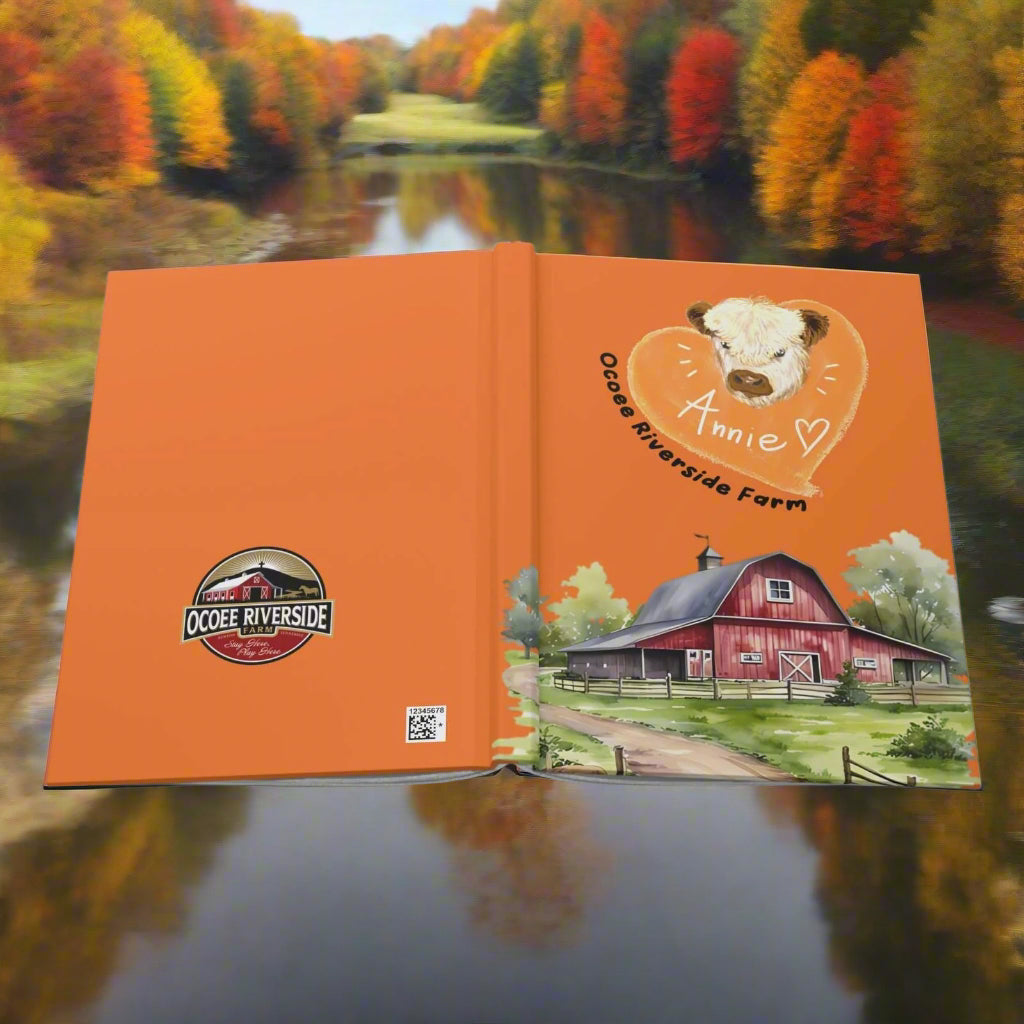 Farm hardcover journal with orange matte cover featuring a cow illustration and a red barn farm scene