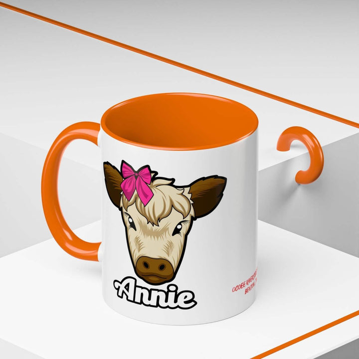 Farmhouse cow coffee mug with red bow design, perfect for rustic kitchen décor.