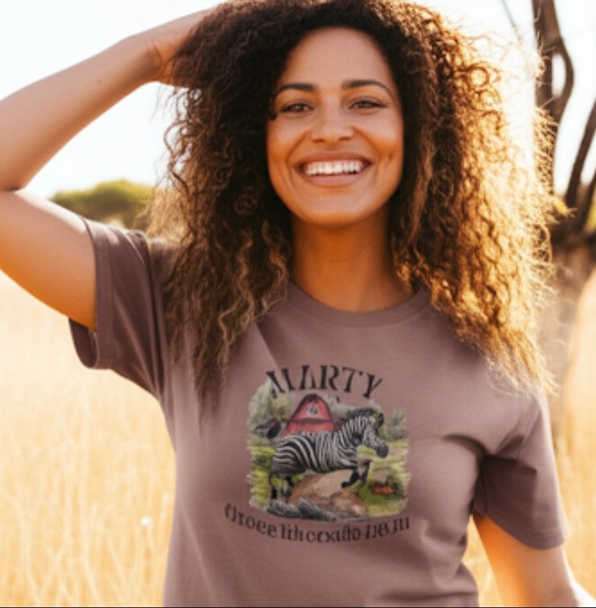 Smiling woman wearing Marty the Zebra T-Shirt with vibrant zebra print outdoors
